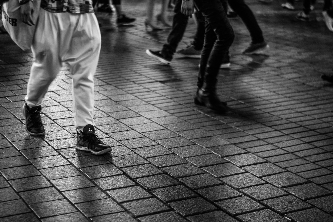 Feet and legs of people walking, black and white