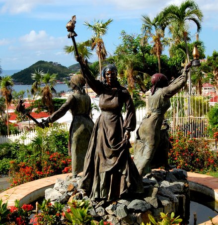 monument showing all three 'Queens' is located in Charlotte Amalie, St. Thomas. All three women are holding up torches.