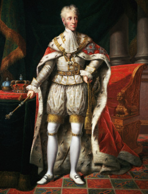 A man dressed in very royal and formal attire. His clothes are predominantly crem white and he wear a long white and red cape. His white hair is styled upwards.