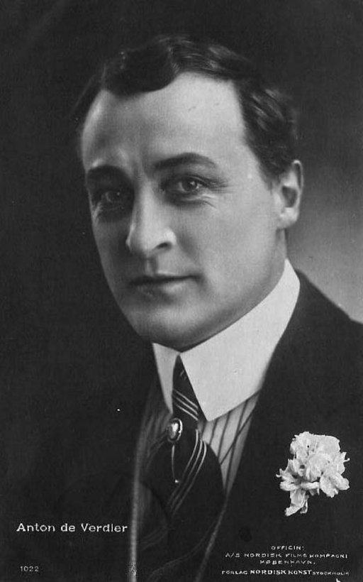 black and white portrait of a middle-aged man wearing a suit and tie with a flower on his chest