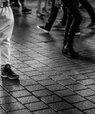 Feet and legs of people walking, black and white