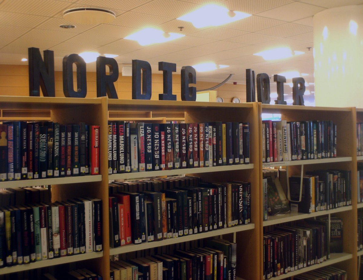 A picture of bookshelves in a library. Above the bookshelves are big letters spelling 'Nordic Noir'.
