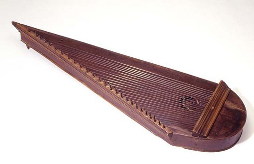 A picture of a wooden instrument. It has two long straight sides which connect with a half-circle, a sort of ice cream cone-shape. From the half-circle are several strings going down to one of the longer sides.
