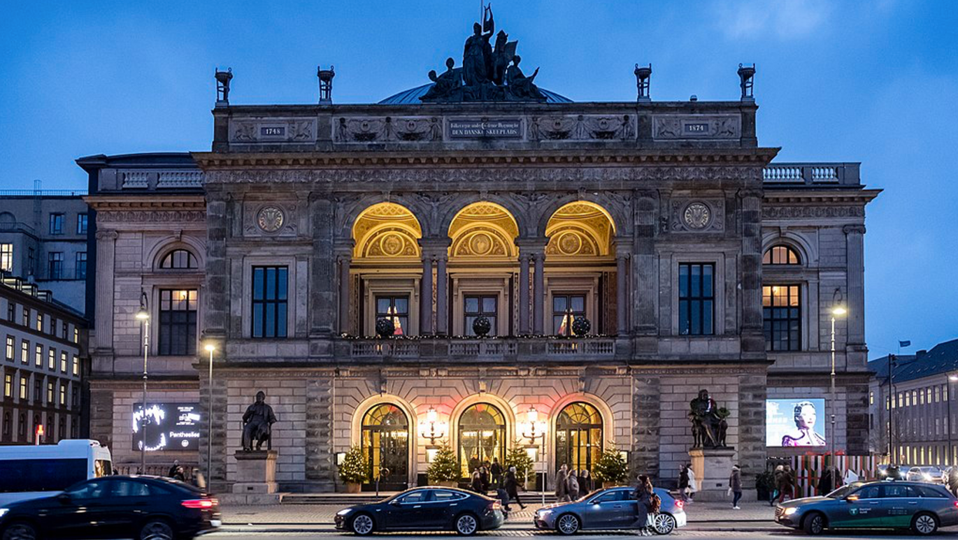 Photo taken in the evening of a large building that lights up.