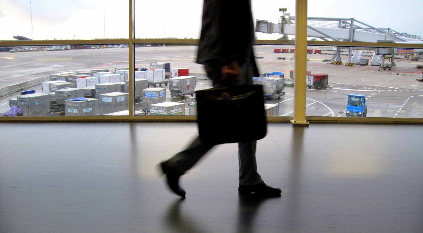 A shot of a man's legs walking in an airport with a briefcase.