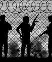 Barbed wire and the silhouette of men with guns in military clothes