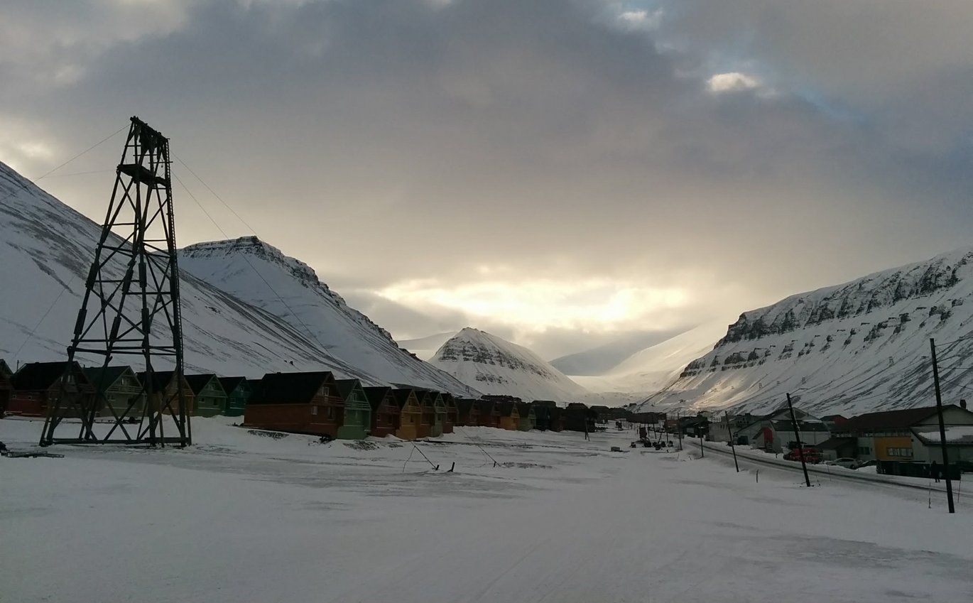 A small arctic village. Small houses next to each other in a snow landscape.