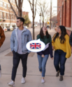 five young people walking together and chatting in different languages