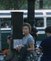 1960s woman looking into camera while waiting for bus to go to work