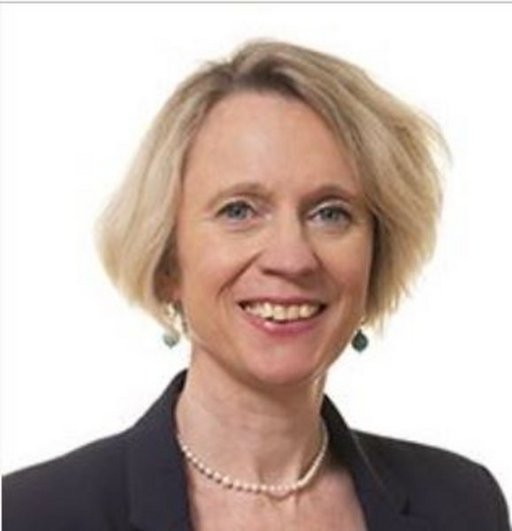 Portrait of a smiling woman in suit with short blond hair