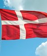 The Danish flag, Dannebrog, coloured red and white waving in the air