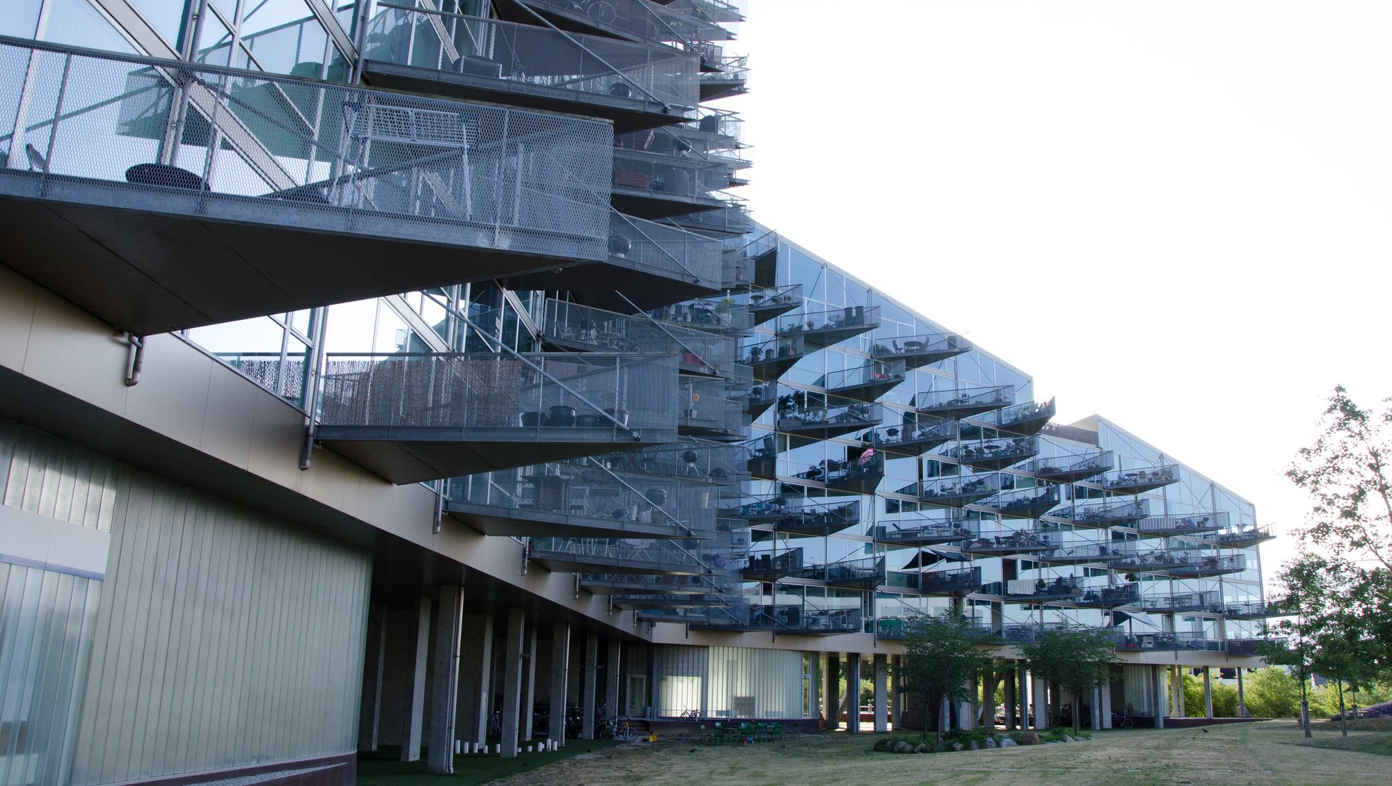 A housing complex made out of glass. What is special about this complex is that the balconies are triangular made by glass aswell. From far away, the balconies together look like spikes.