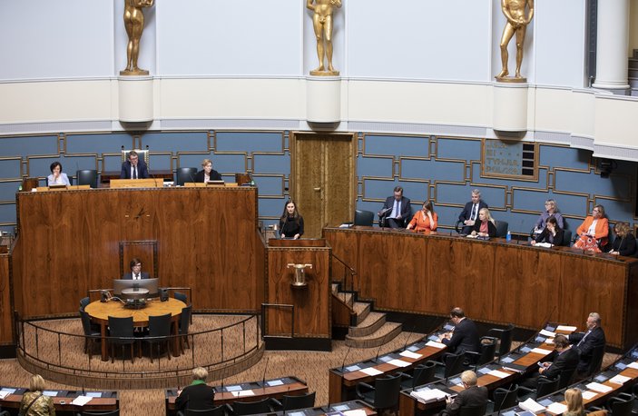 Finnish Parliament with member seated and discussing