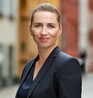 A portrait of Danish woman in a sleek bun and a suit