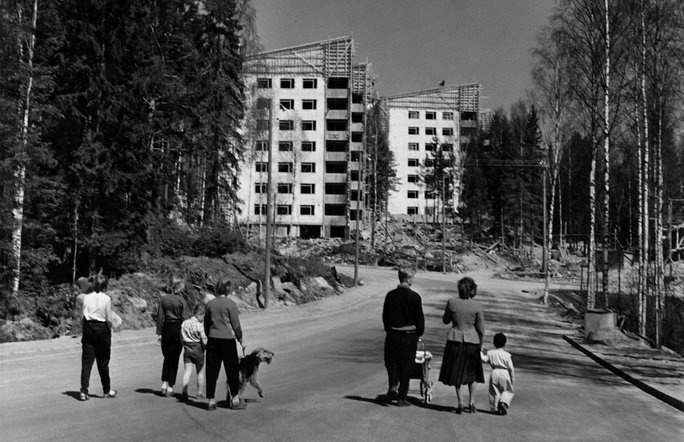 People of all ages walking near Helsinki, Finland in 1957, where in the background new housing is under construction.