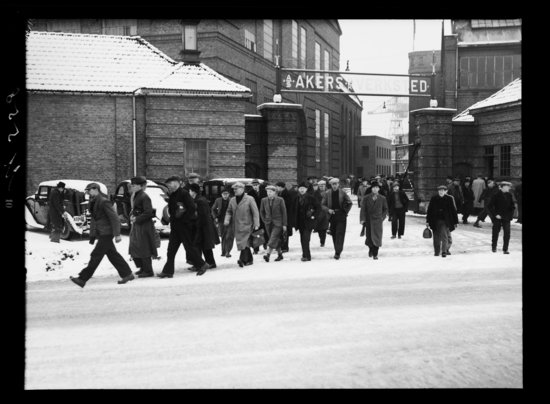 Black and white photograph of a ship yardfrom 1939 with men walking