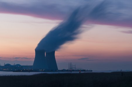 Powerplants in the evening with smoke coming out of them