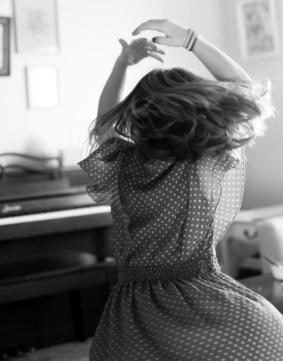 a young child (girl) spinning around dancing 