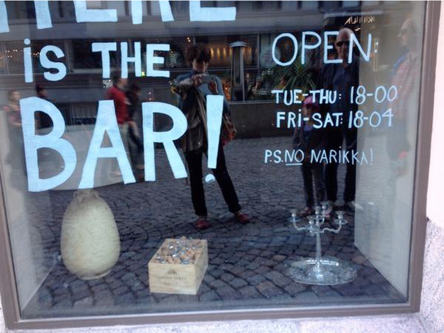 A bar window with text written on it both in English and Finnish