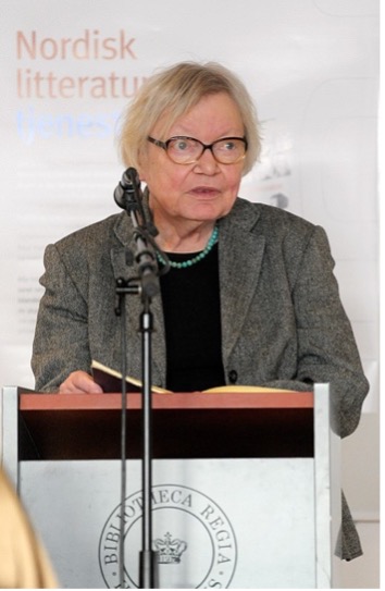 Portrait shot of an elder woman perfoming a speech at a stand