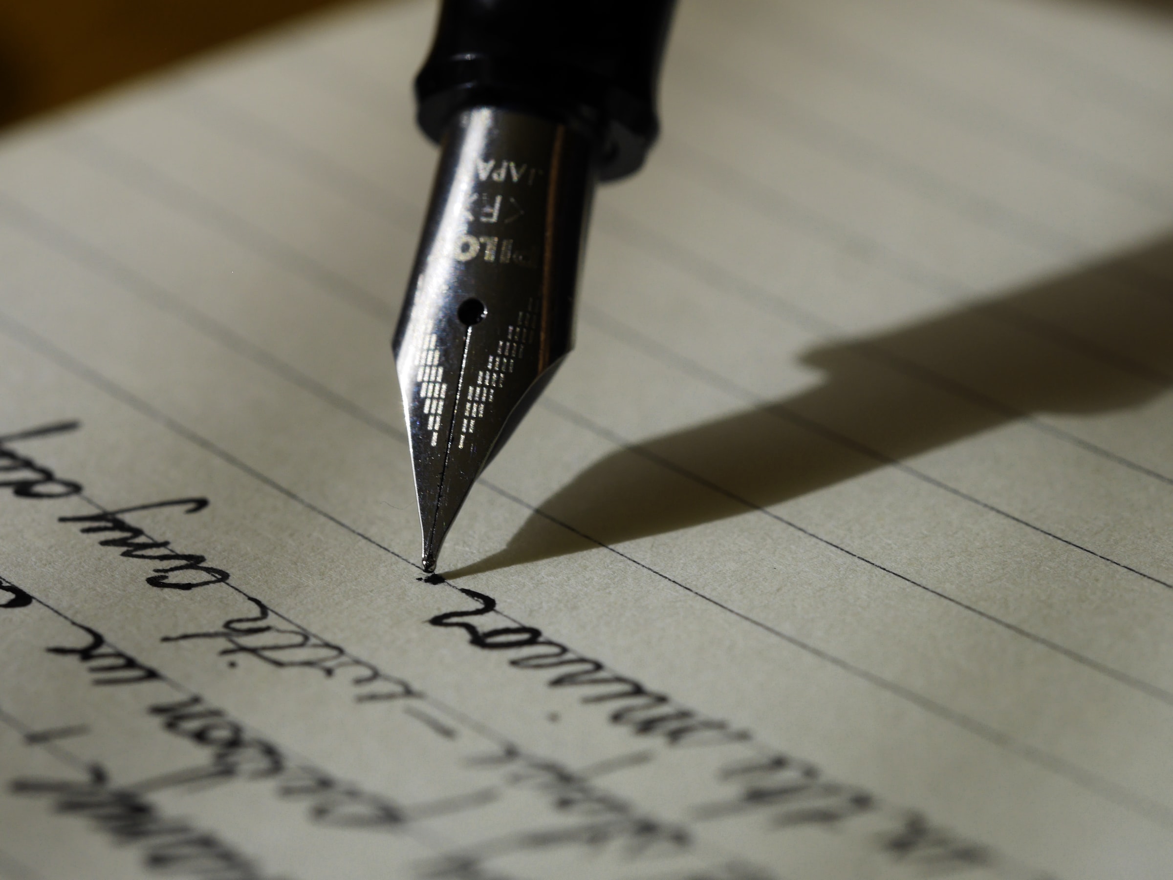 Ink pen writing on a notepad