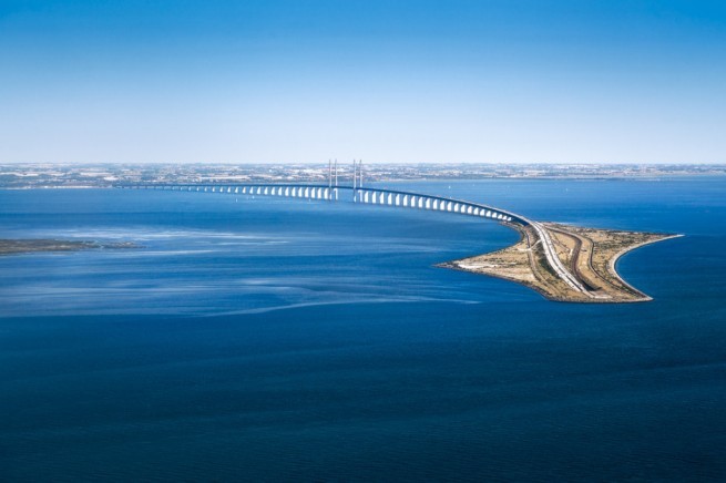 The Oresund bridge (Øresundsbron) viewed from a plane taking off from Kastrup Airport, Copenhagen. A long bridge surrounded by the sea.