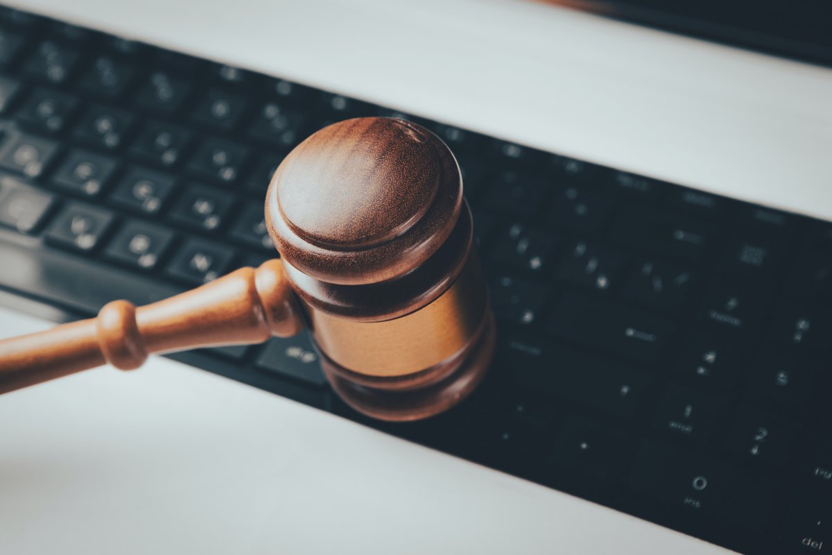 A picture of a gavel in front of a keyboard.