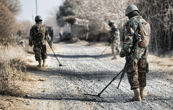 soldiers with metal detectors looking for bombs