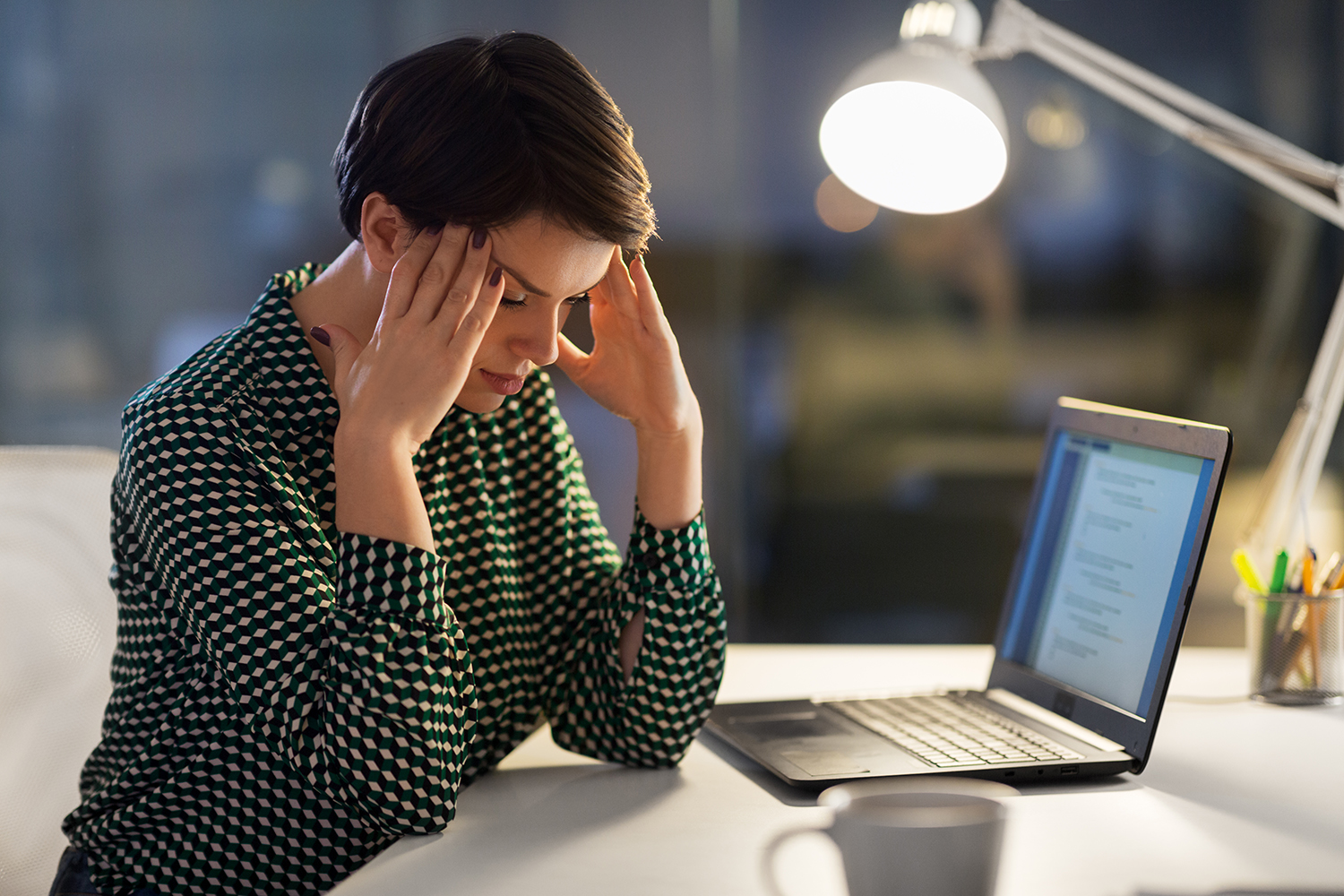 A stressed woman sitting by her desk