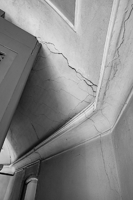 black and white photo of a cracked corner in a church