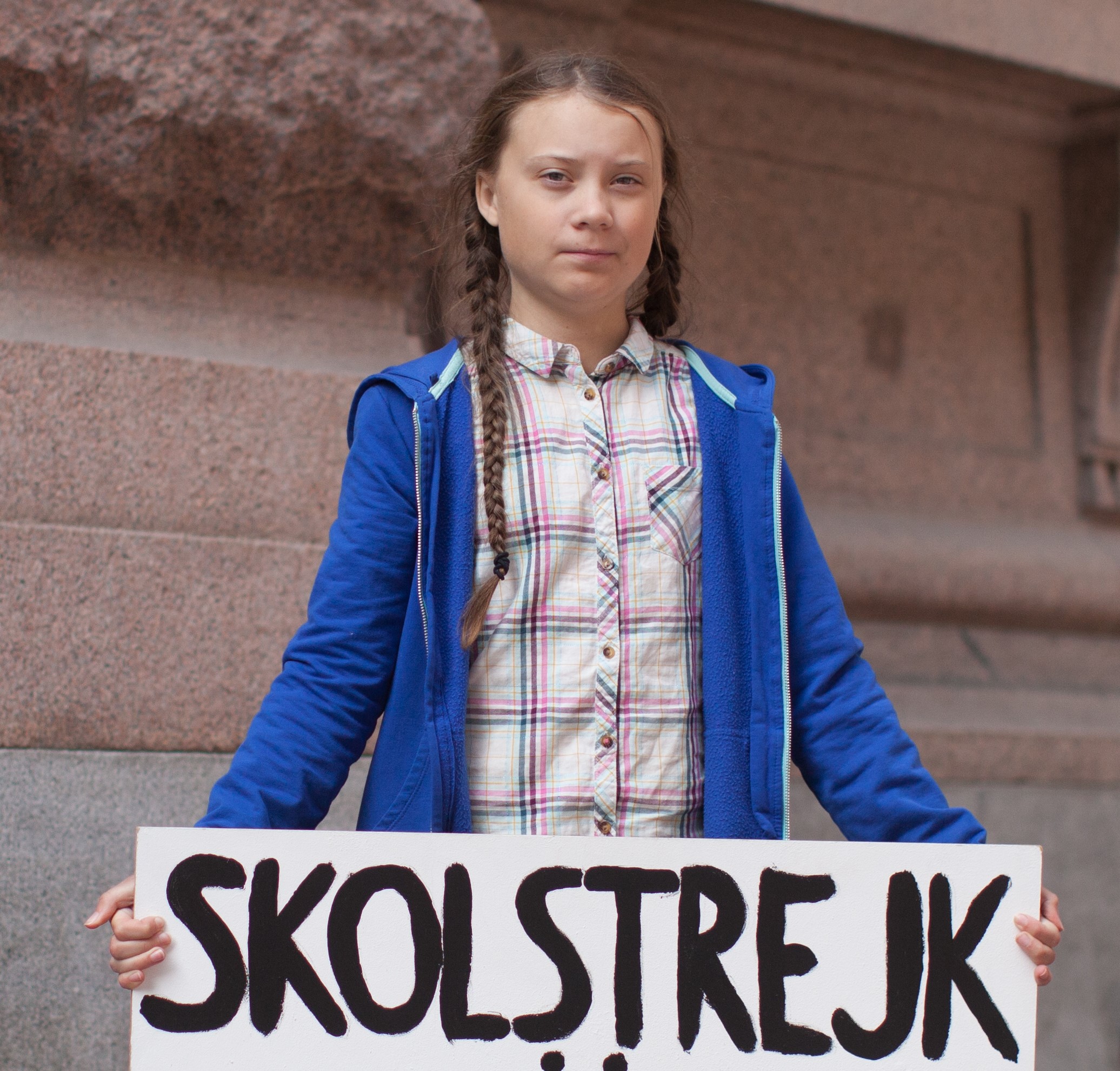 Greta Thunberg holding her original sign saying 'Skolstrejk för klimatet' [School strike for the climate].