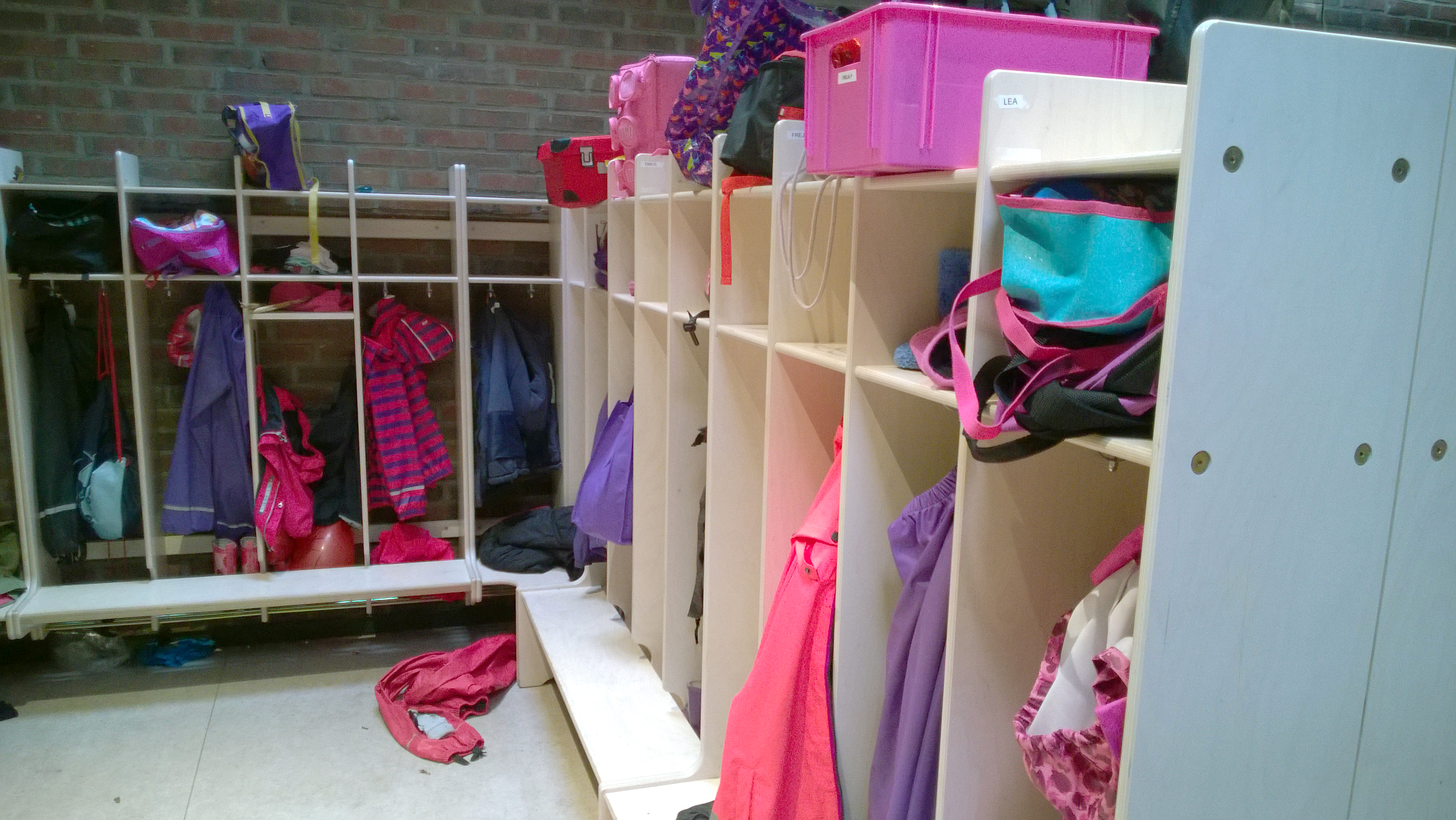 Kindergarten wardrobe, lots of coloured jackets hanging
